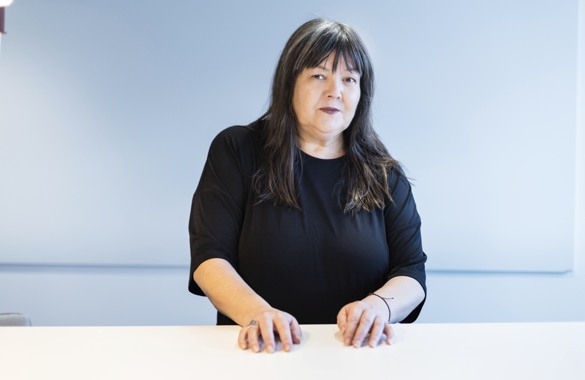 Mara O'Donnell, MTM:s klarspråksansvarige. Hon har en savrt tröja och står mot en blå bakgrund.